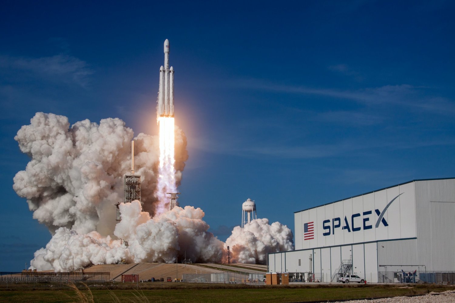 spacex hangar with rocket taking off