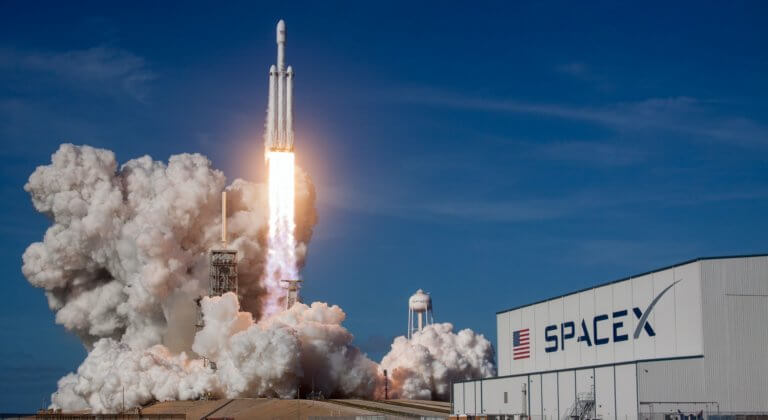 spacex hangar with rocket taking off